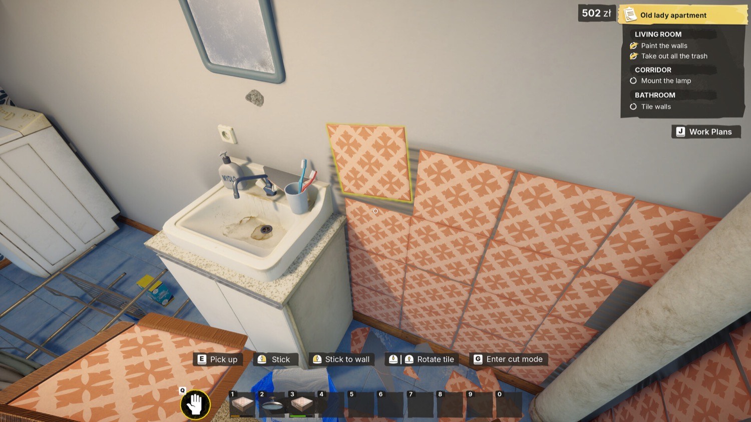 Official Low-Budget Repairs gameplay screenshot showing uneven patterned tiles being placed around a bathroom sink
